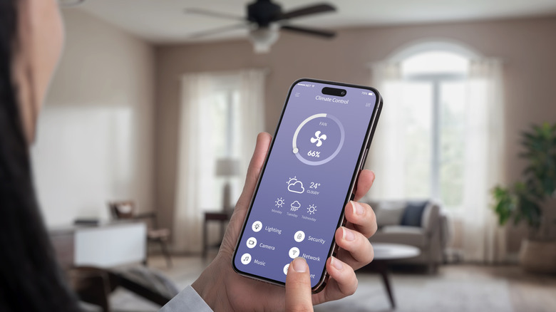 Woman changing a ceiling fan's settings with an app