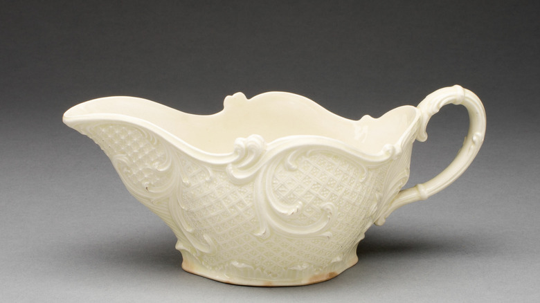 An antique white creamer Queen's Ware dish.
