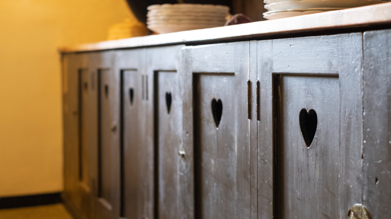 Bottom cabinet doors in brown with heart cutouts