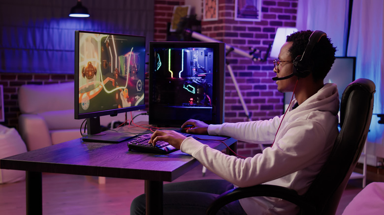 Young adult man gaming sitting in gaming chair