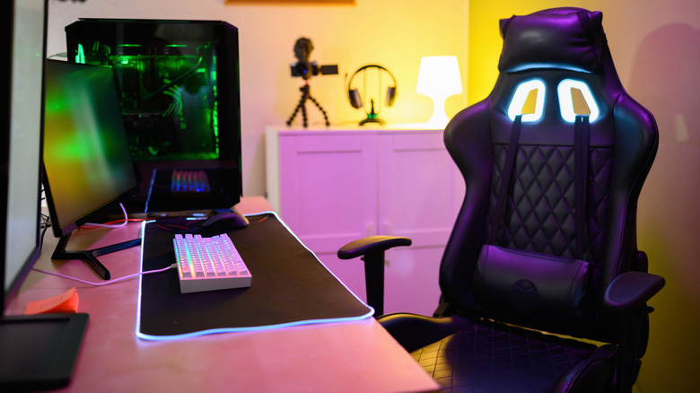 Gaming chair next to a gaming setup on desk