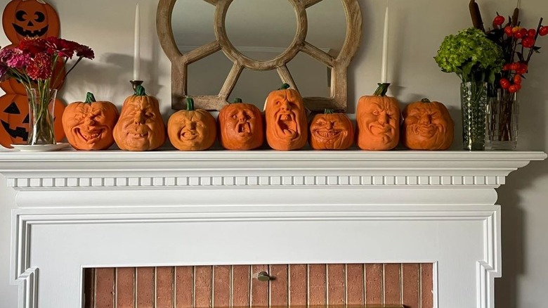 Oh Lantern Family pumpkins lined up on fireplace mantle