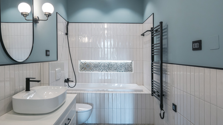 Bathroom with black tile trim