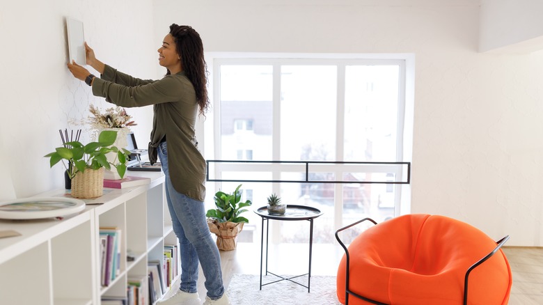 Woman hanging photos