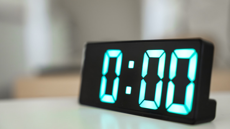 Close-up of a digital clock showing midnight