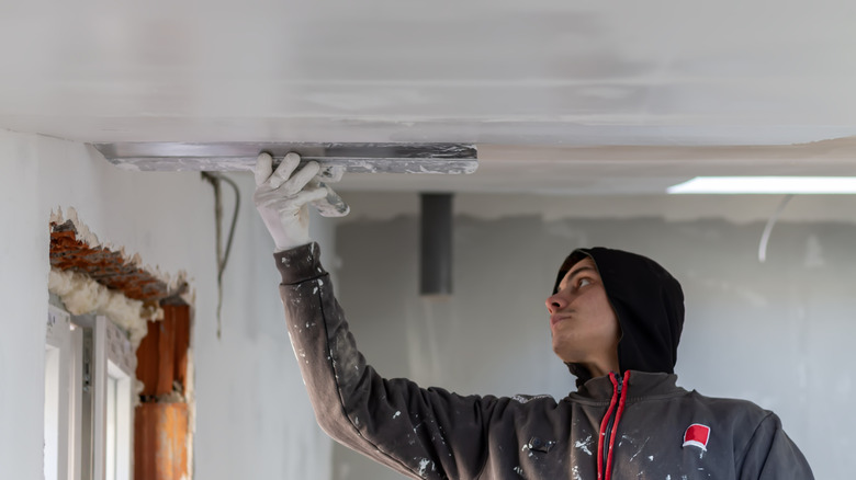 Skim-coating a ceiling with a large drywall knife