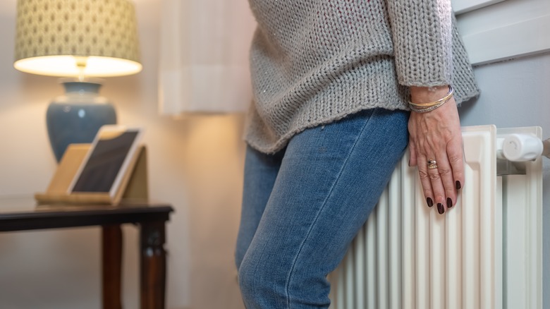 person next to heater