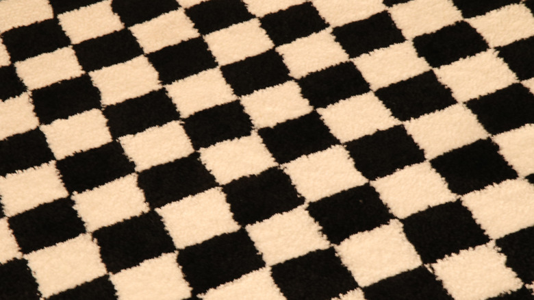 Closeup of a small-scale, black and white checkerboard print rug