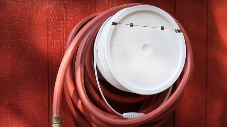 Garden hose bucket holder