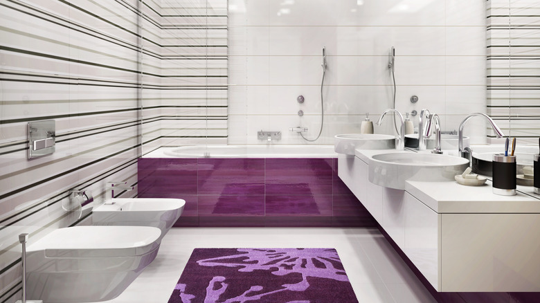 white, beige, and purple bathroom with outdated horizontal stripe pattern on walls