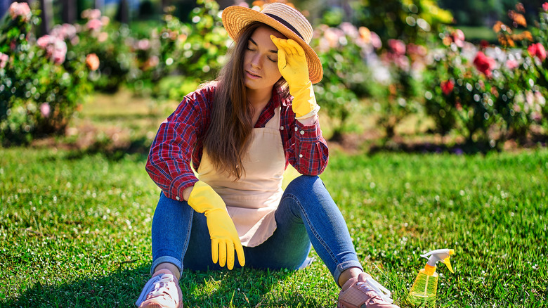 woman sitting in garden regretful