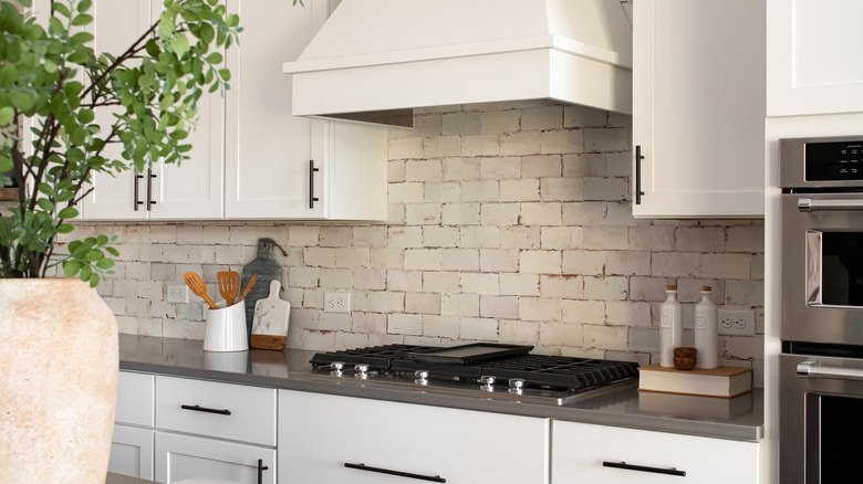 natural stone brick backsplash in white modern rustic kitchen