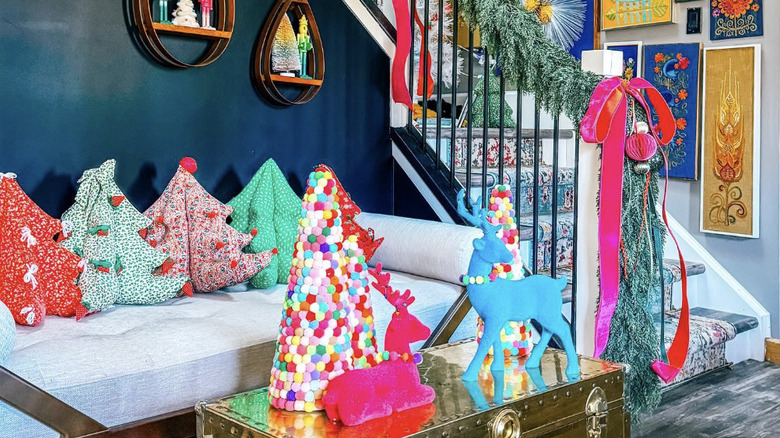 A seating area decorated with colorful maximalist Christmas decorations