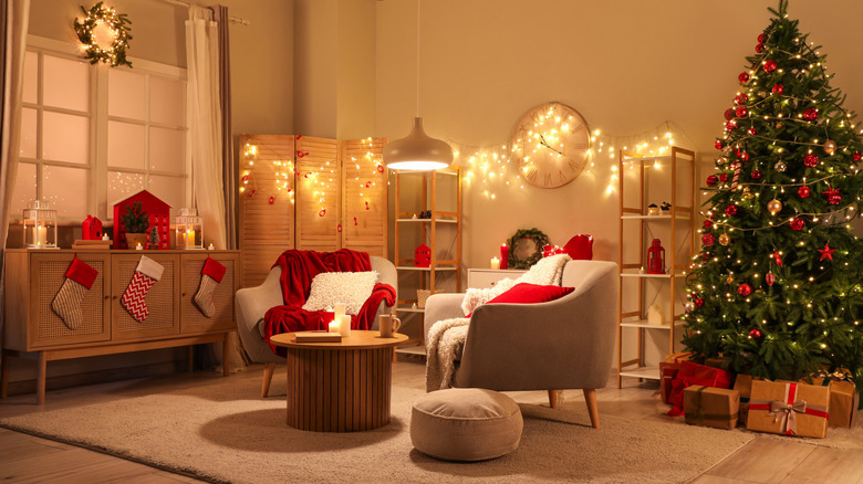 a living room with warm lighting and Christmas decorations