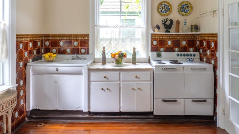 Ernest Hemingway's 1930s Key West kitchen with window and countertop between white stove and sink