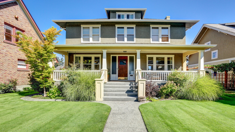 Two story Craftsman home with front porch and landscaped yard