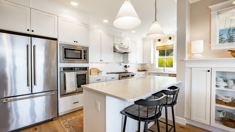 White kitchen with stainless steel appliances