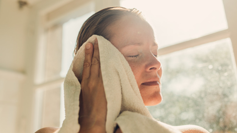 Person rubbing soft towel on face