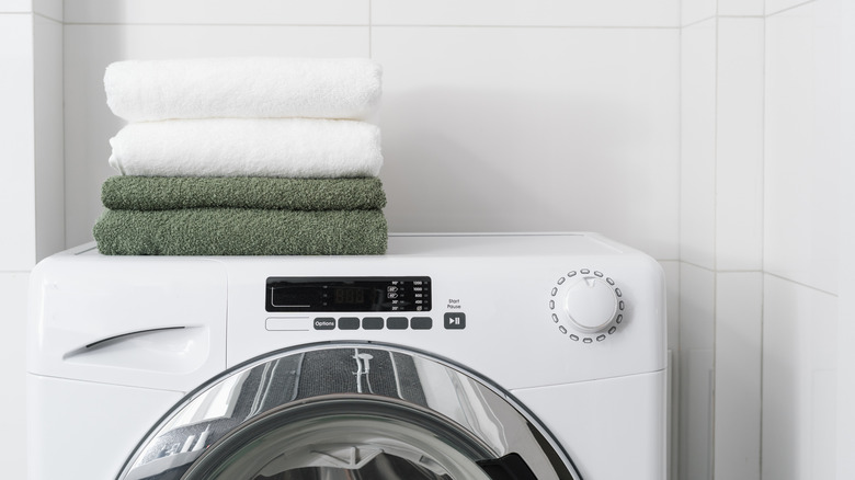 Fresh fluffy towels on a washing machine