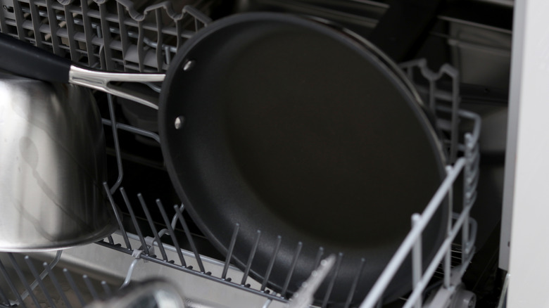 Black nonstick pan in dishwasher.