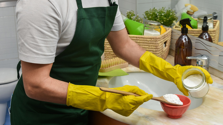 Man pouring baking soda into bowl