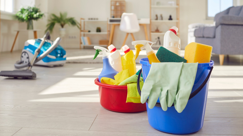 Cleaning supply buckets and a vacuum