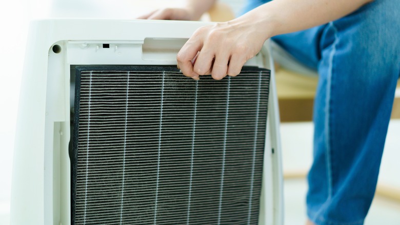 Person changing a dirty air filter