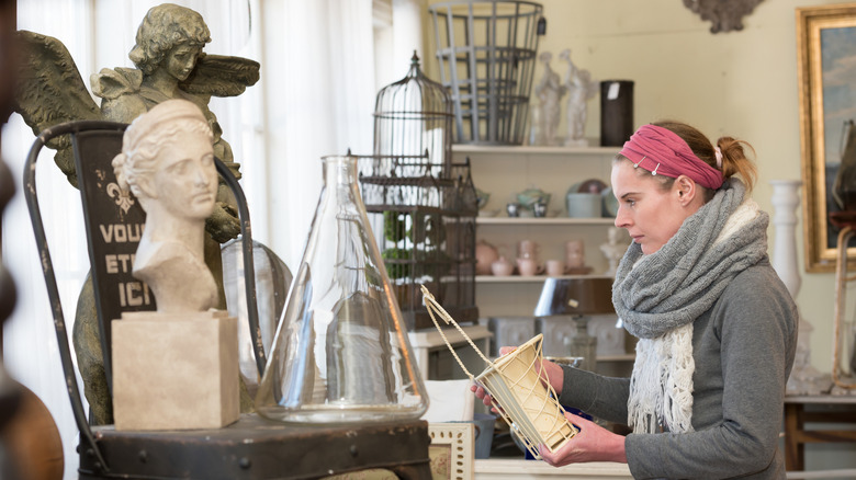 A person looking at vintage items in a thrift store.