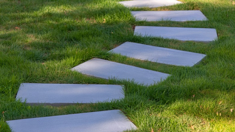 Rectangular stepping stones winding across a lawn