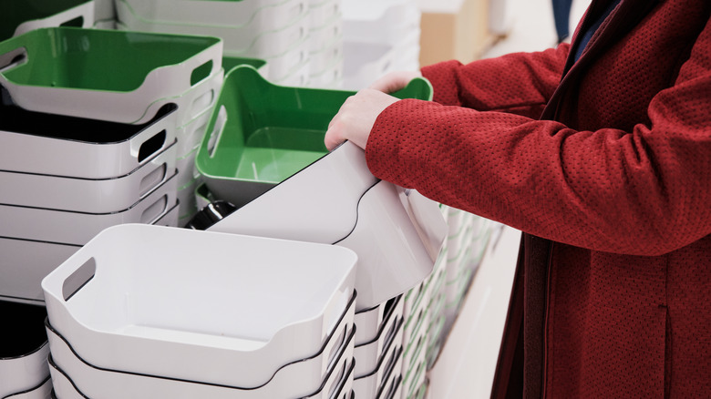 woman looks at storage containers