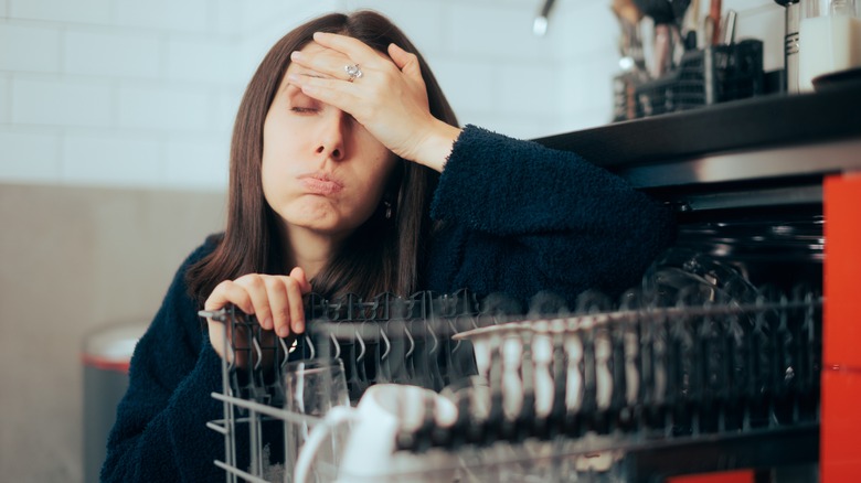 upset woman with a dishwasher