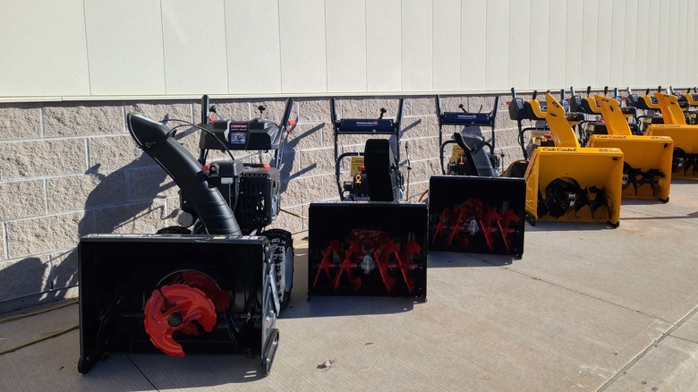 Snow blowers for sale outside a hardware store.