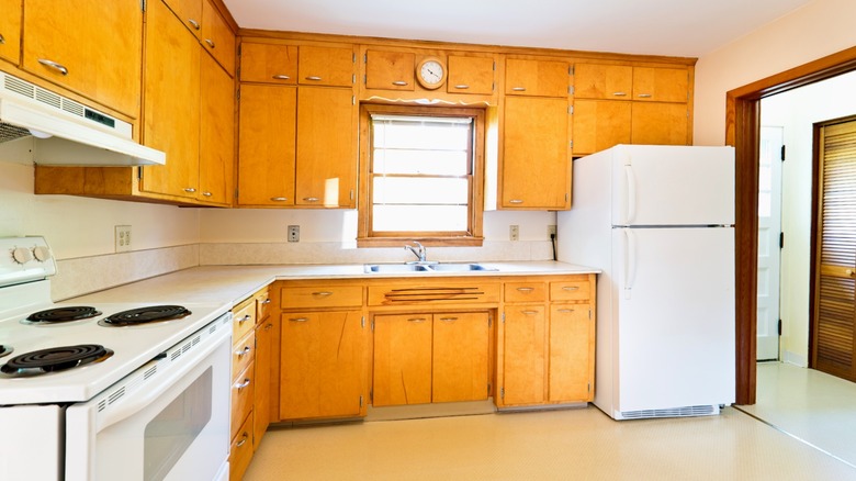 Outdated 1950s style wood kitchen cabinets
