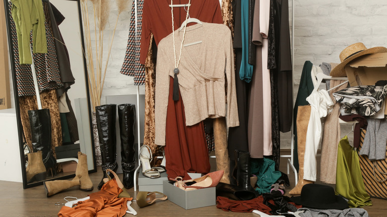 Cluttered closet full of clothes