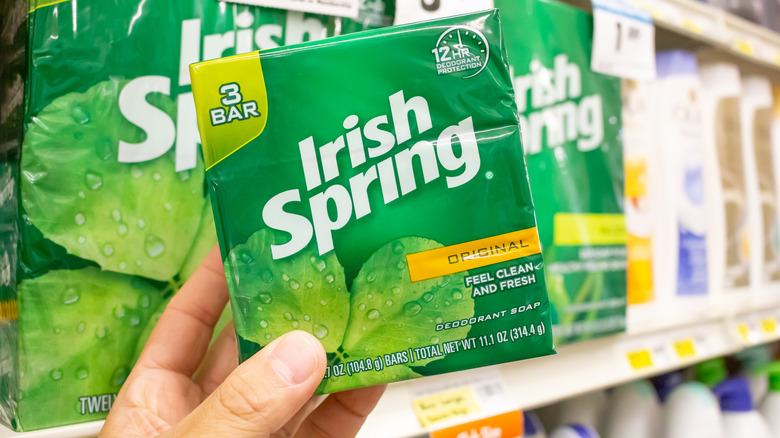 Hand holding a package of Irish Spring bar soap in store
