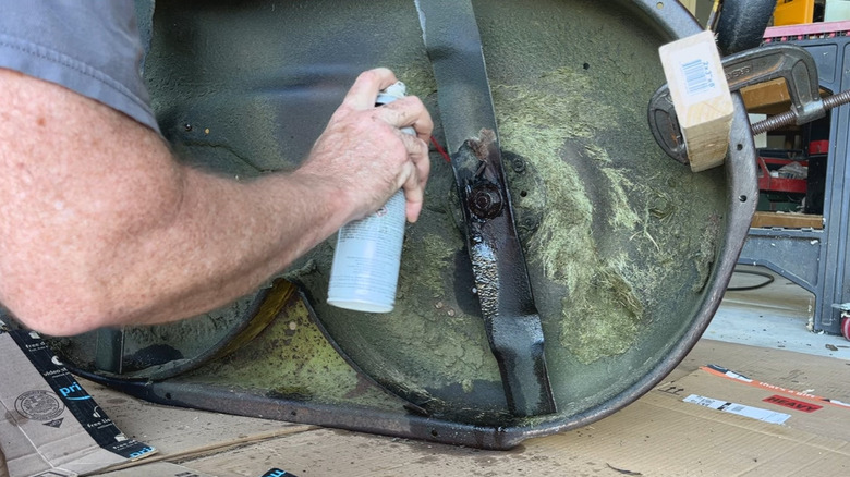 Someone applying oil on a bolt