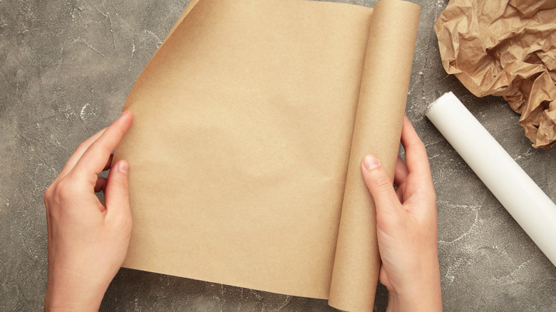 Woman opening the roll of wax paper