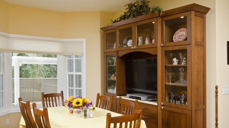 a kitchen with a large wooden china cabinet