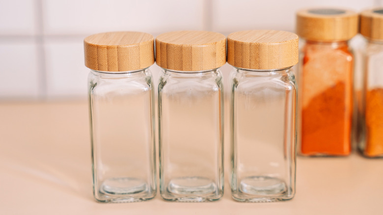 three empty glass spice jars on a countertop