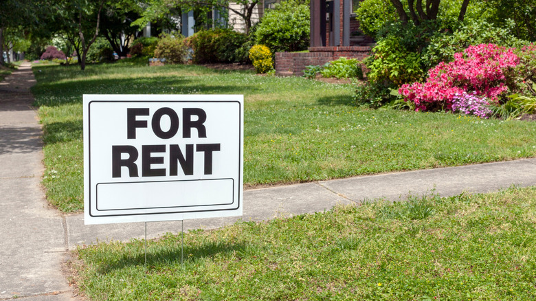 "For Rent" sign in yard 