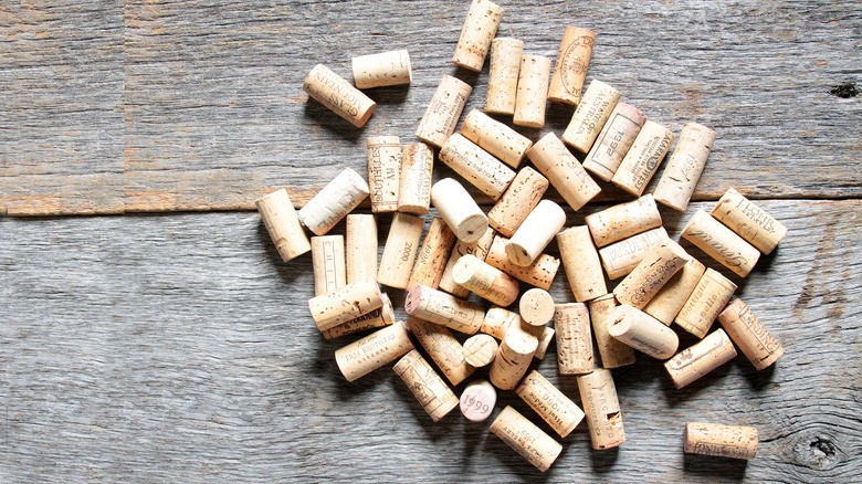 Pile of old wine corks on wooden background