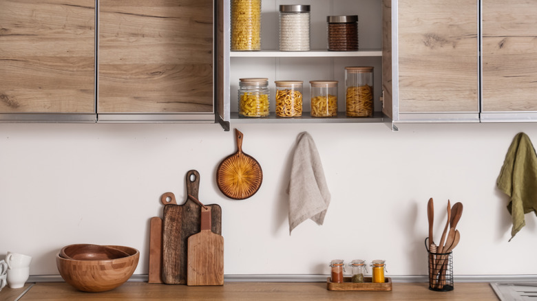 Kitchen cabinets with utensils and jars