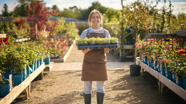happy woman working garden center