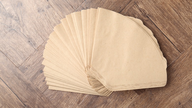 Stack of coffee filters on a wooden surface