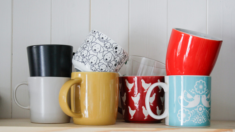 Messy stack of empty coffee mugs