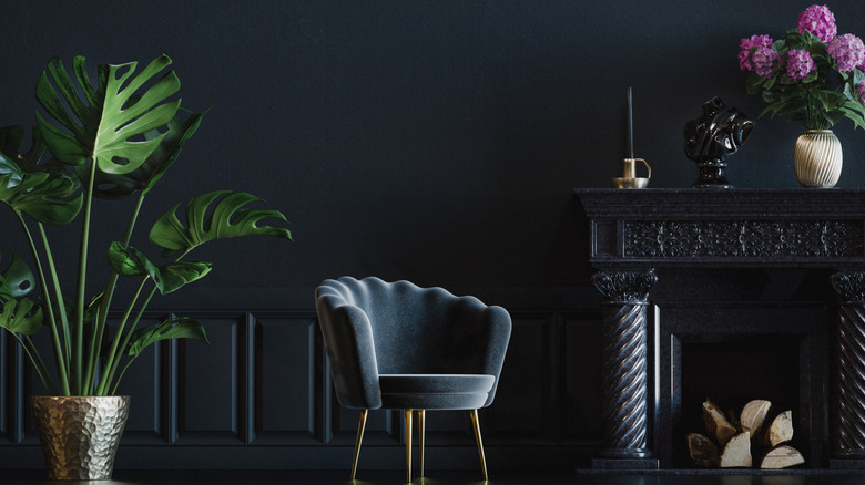dark blue color-drenched room with painted fireplace and waistcoat