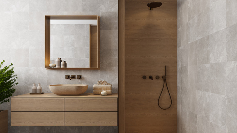 A modern, Japanese-styled bathroom with wet shower and floating wooden vanity.