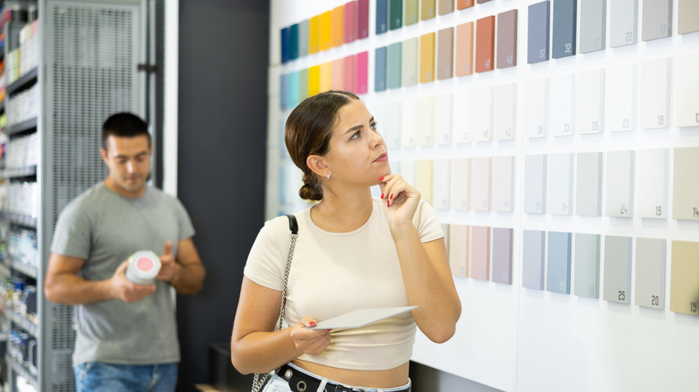 Woman looking at paint swatches at a store