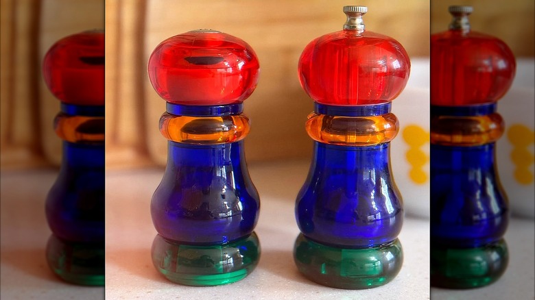Colorful blue, green, blue, orange, and red Olde Thompson Sunset Fiesta salt shaker and pepper mill.