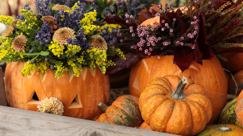 pumpkins with flowers in them